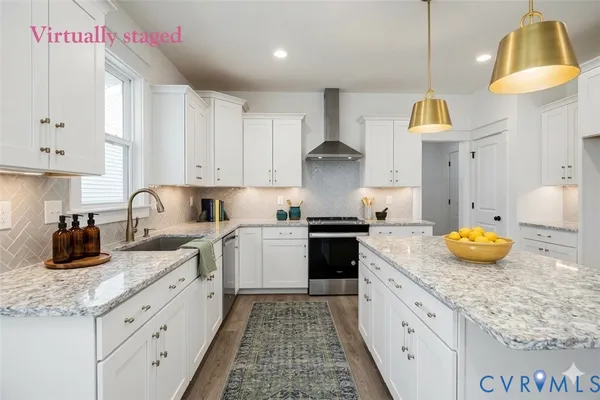 a kitchen with granite countertop a sink a stove and cabinets