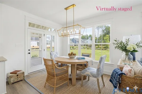 a dining room with furniture a chandelier and window