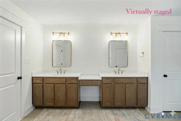 a bathroom with double vanity sinks and a mirror