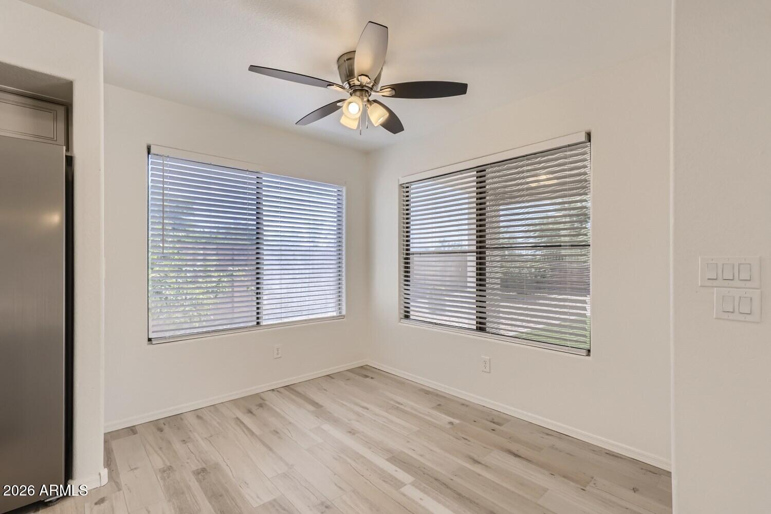 16033 West Diamond Street Goodyear, AZ 85338 - Photo 11 of 28 a view of an empty room with wooden floor and a window
