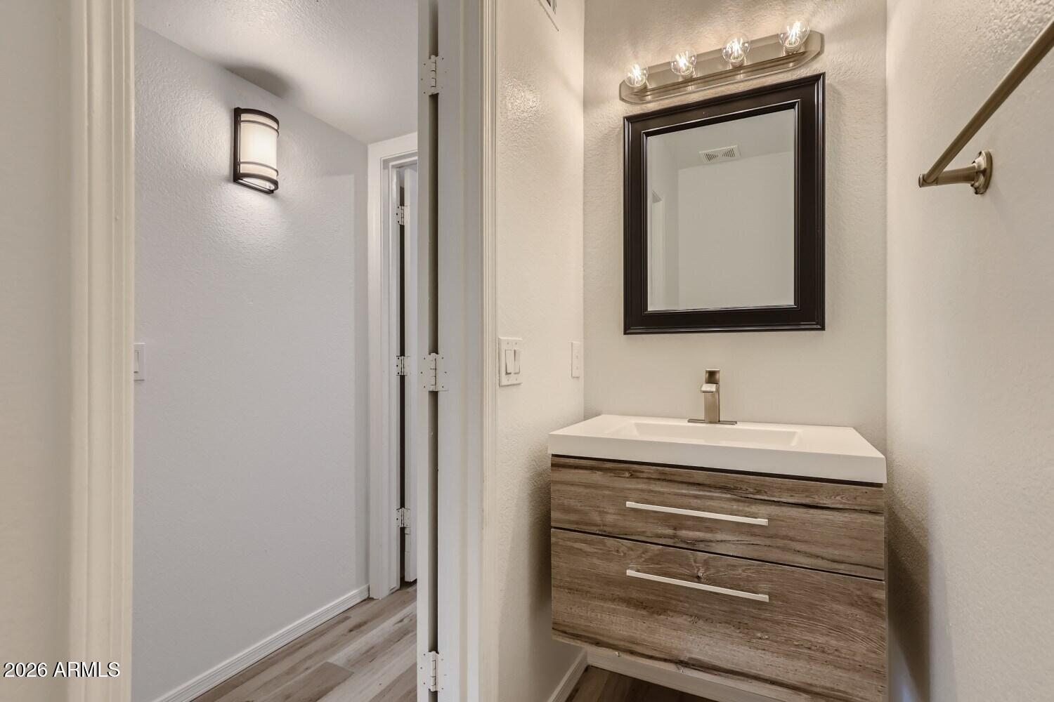 16033 West Diamond Street Goodyear, AZ 85338 - Photo 12 of 28 a bathroom with a sink and a mirror