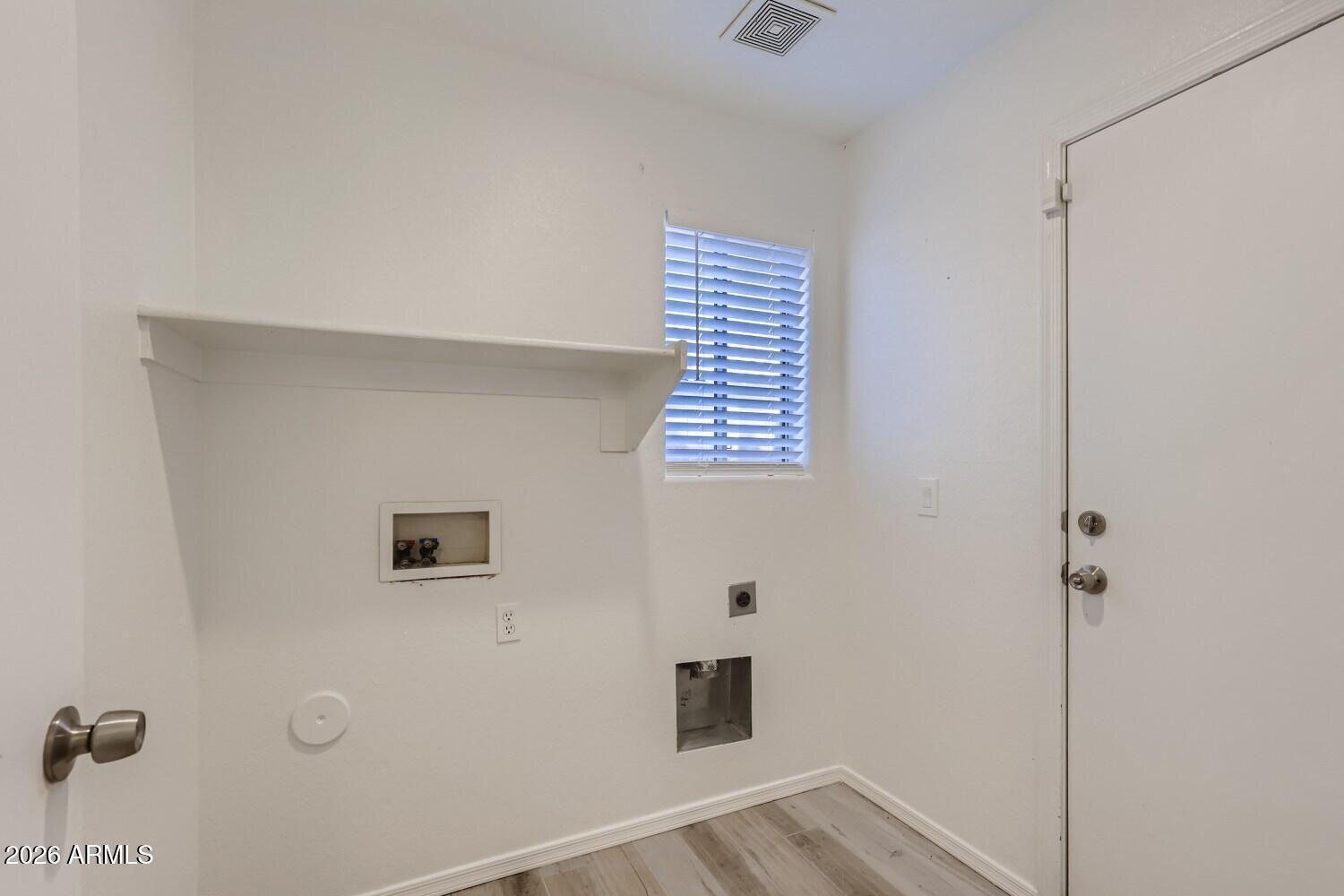 16033 West Diamond Street Goodyear, AZ 85338 - Photo 13 of 28 a view of a hallway with wooden floor