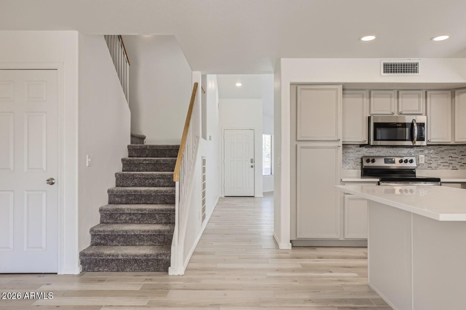 16033 West Diamond Street Goodyear, AZ 85338 - Photo 15 of 28 a view of a kitchen with wooden floor and electronic appliances