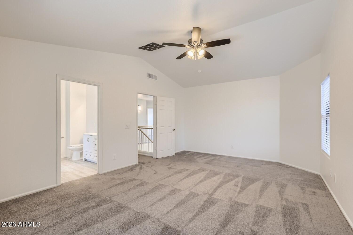 16033 West Diamond Street Goodyear, AZ 85338 - Photo 16 of 28 a view of an empty room with chandelier fan and fire place