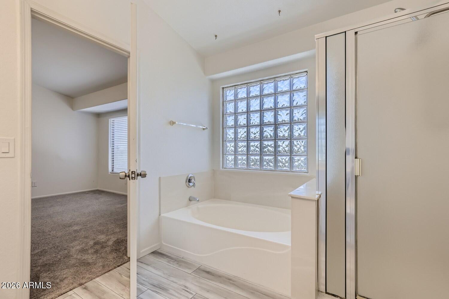 16033 West Diamond Street Goodyear, AZ 85338 - Photo 19 of 28 a bathroom with a bathtub and a shower