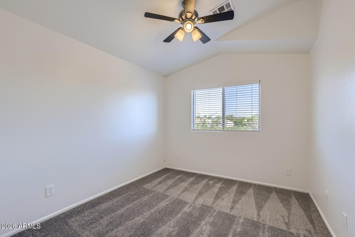 16033 West Diamond Street Goodyear, AZ 85338 - Photo 21 of 28 an empty room with a window and a fan