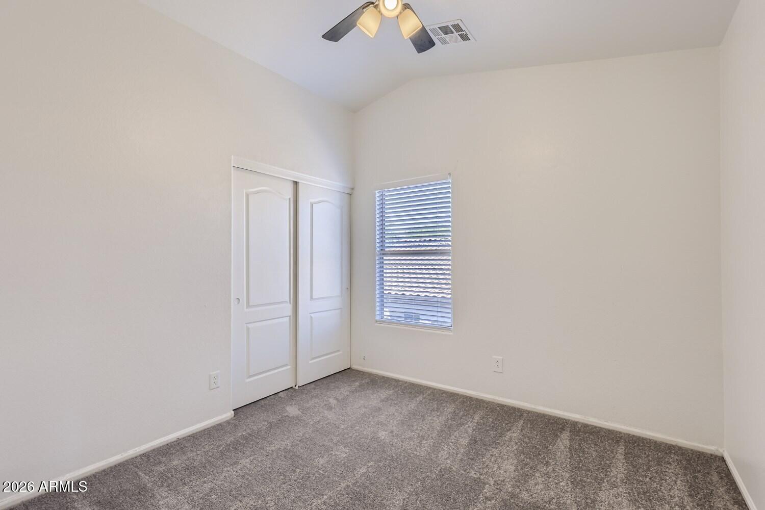 16033 West Diamond Street Goodyear, AZ 85338 - Photo 24 of 28 an empty room with chandelier fan