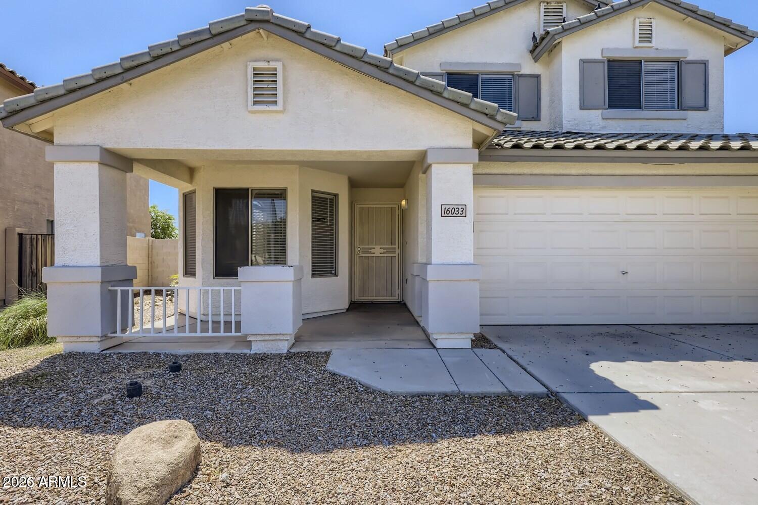 16033 West Diamond Street Goodyear, AZ 85338 - Photo 3 of 28 a front view of a house with garden