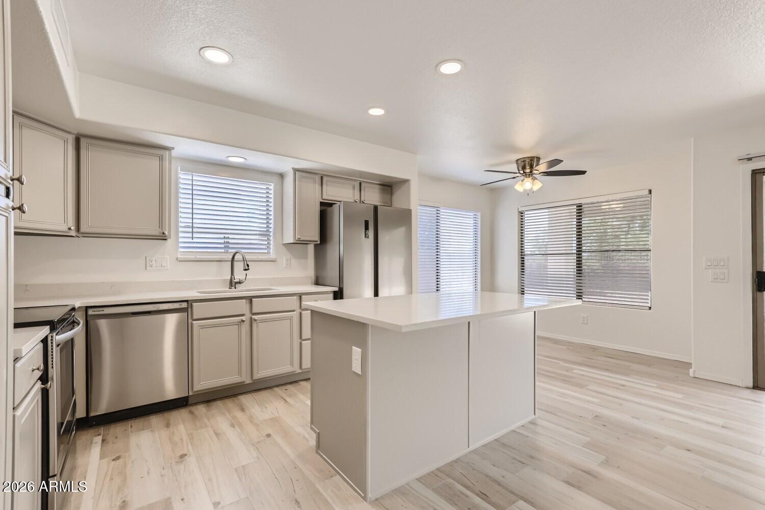 16033 West Diamond Street Goodyear, AZ 85338 - Photo 6 of 28 a kitchen with white cabinets and sink