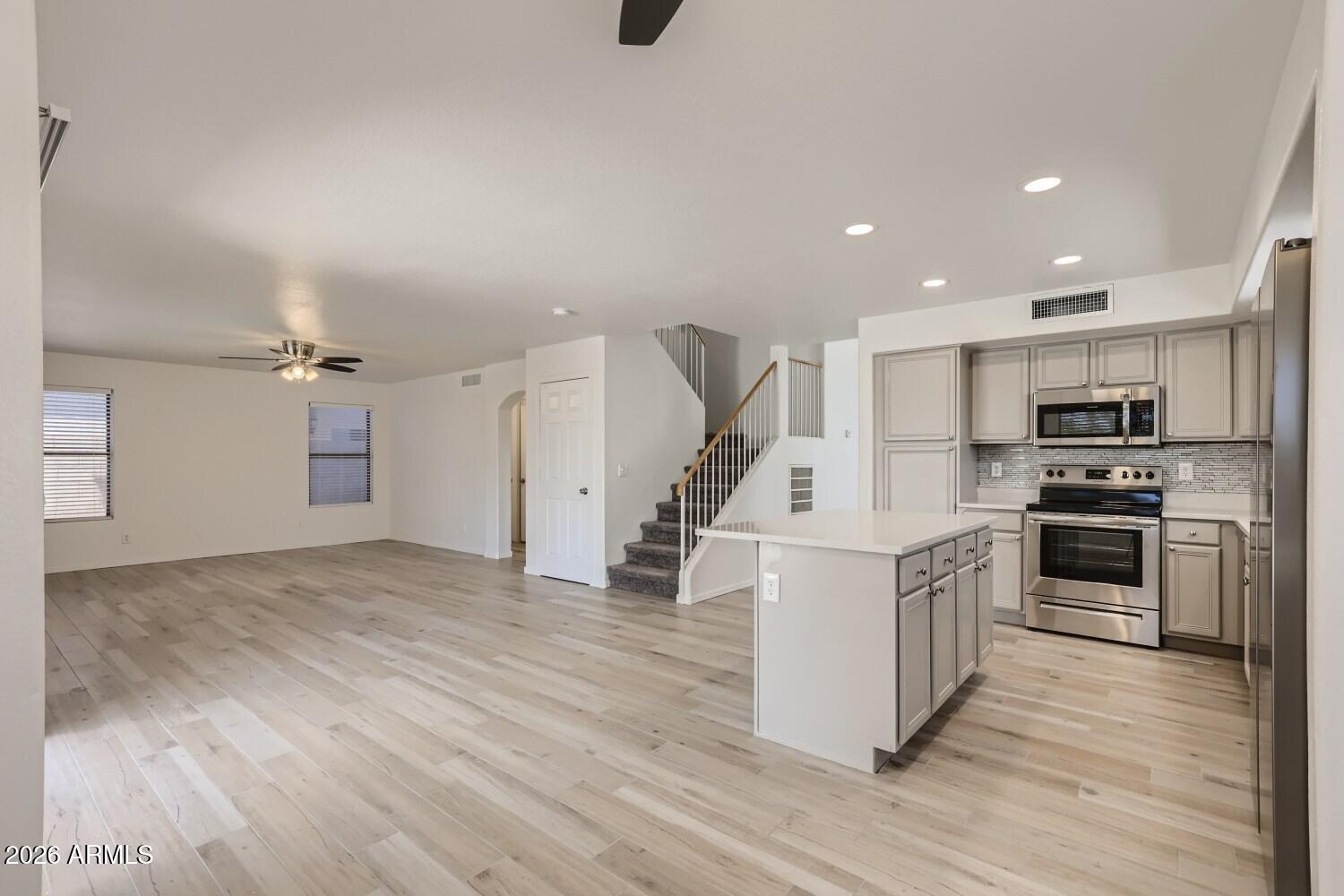 16033 West Diamond Street Goodyear, AZ 85338 - Photo 8 of 28 a kitchen with stainless steel appliances a refrigerator and a stove top oven