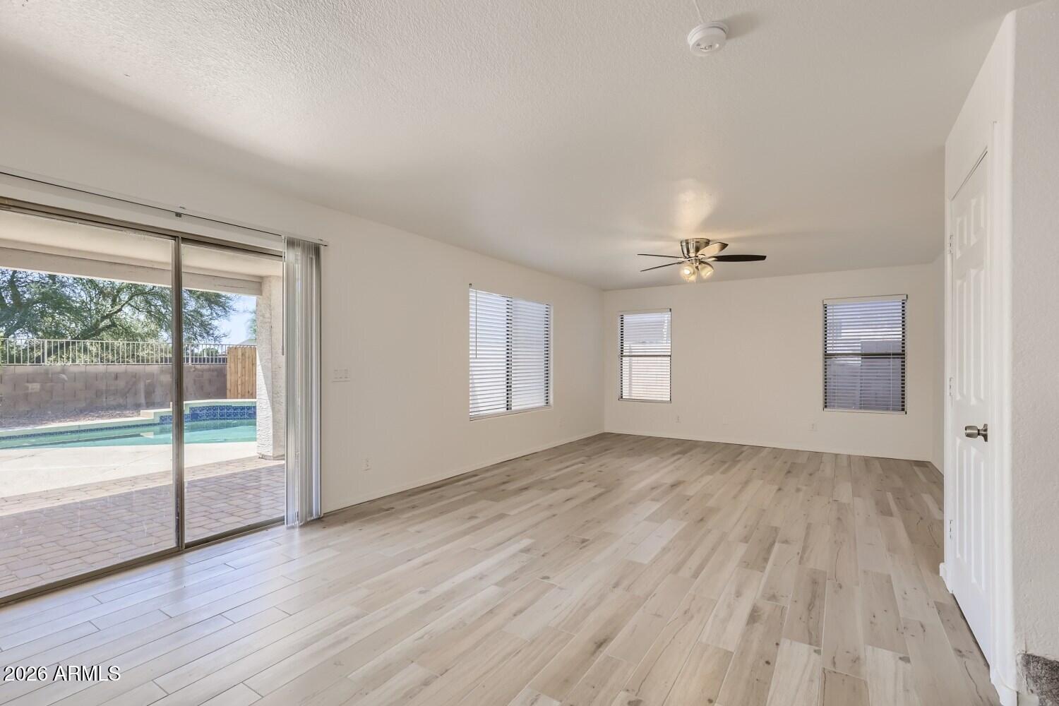16033 West Diamond Street Goodyear, AZ 85338 - Photo 10 of 28 wooden floor in an empty room with a window