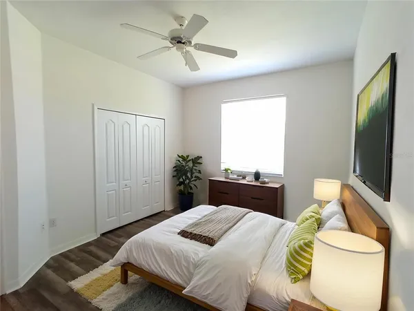 a bedroom with a bed and a flat screen tv