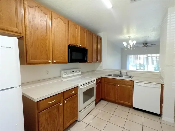 a kitchen with a sink stove and microwave