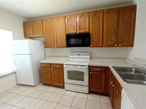 a kitchen with a stove top oven sink and cabinets