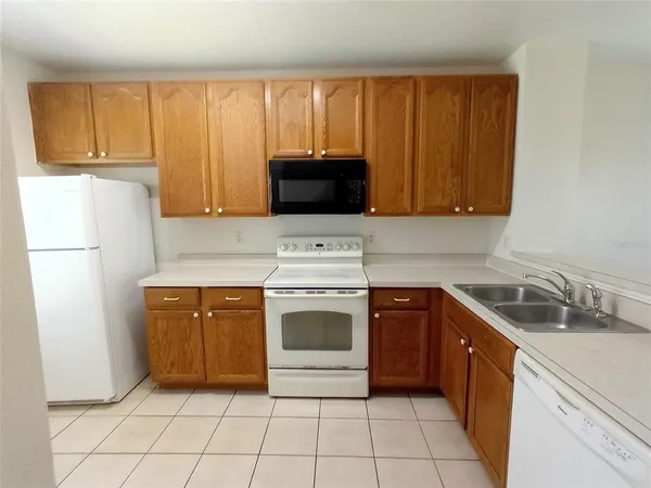 a kitchen with a stove sink and cabinets
