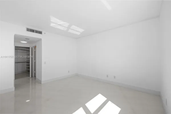 a living room with furniture and potted plants