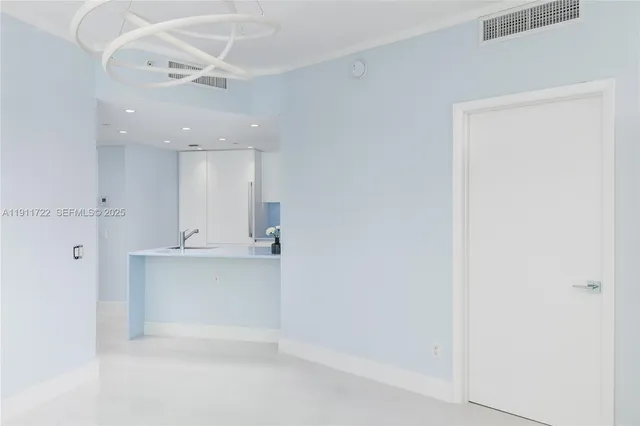 a kitchen with a sink a microwave and cabinets
