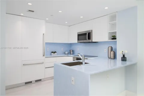 a kitchen with stainless steel appliances white cabinets and a stove