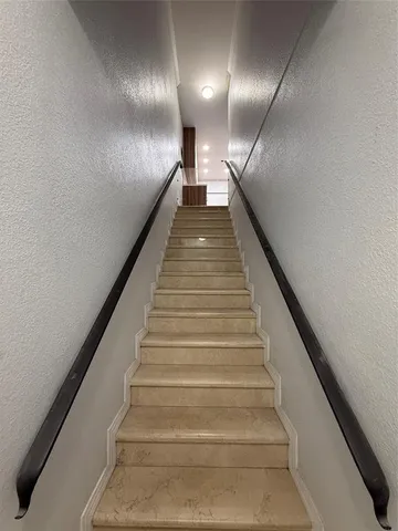 a kitchen with stainless steel appliances a refrigerator sink and microwave