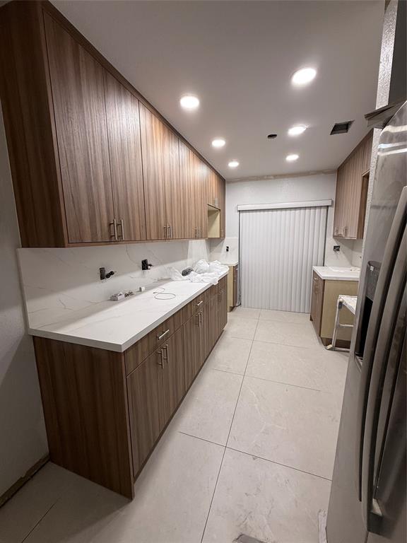 3526 West 76th Street, Unit 203 Hialeah, FL 33018 - Photo 6 of 13 a kitchen with stainless steel appliances kitchen island granite countertop wooden cabinets a sink and a stove