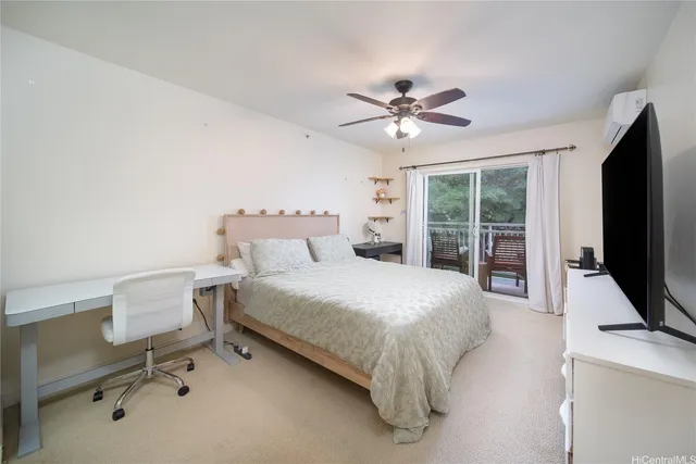 a bedroom with a bed tv and a window