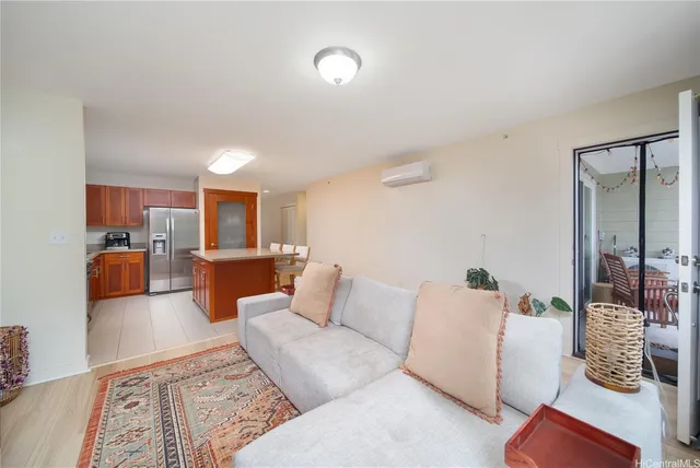 a living room with furniture and view of kitchen