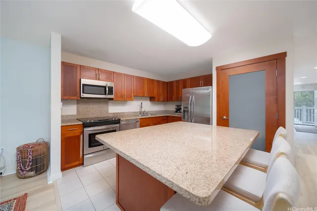 a kitchen with stainless steel appliances granite countertop a stove top oven a sink dishwasher and a refrigerator