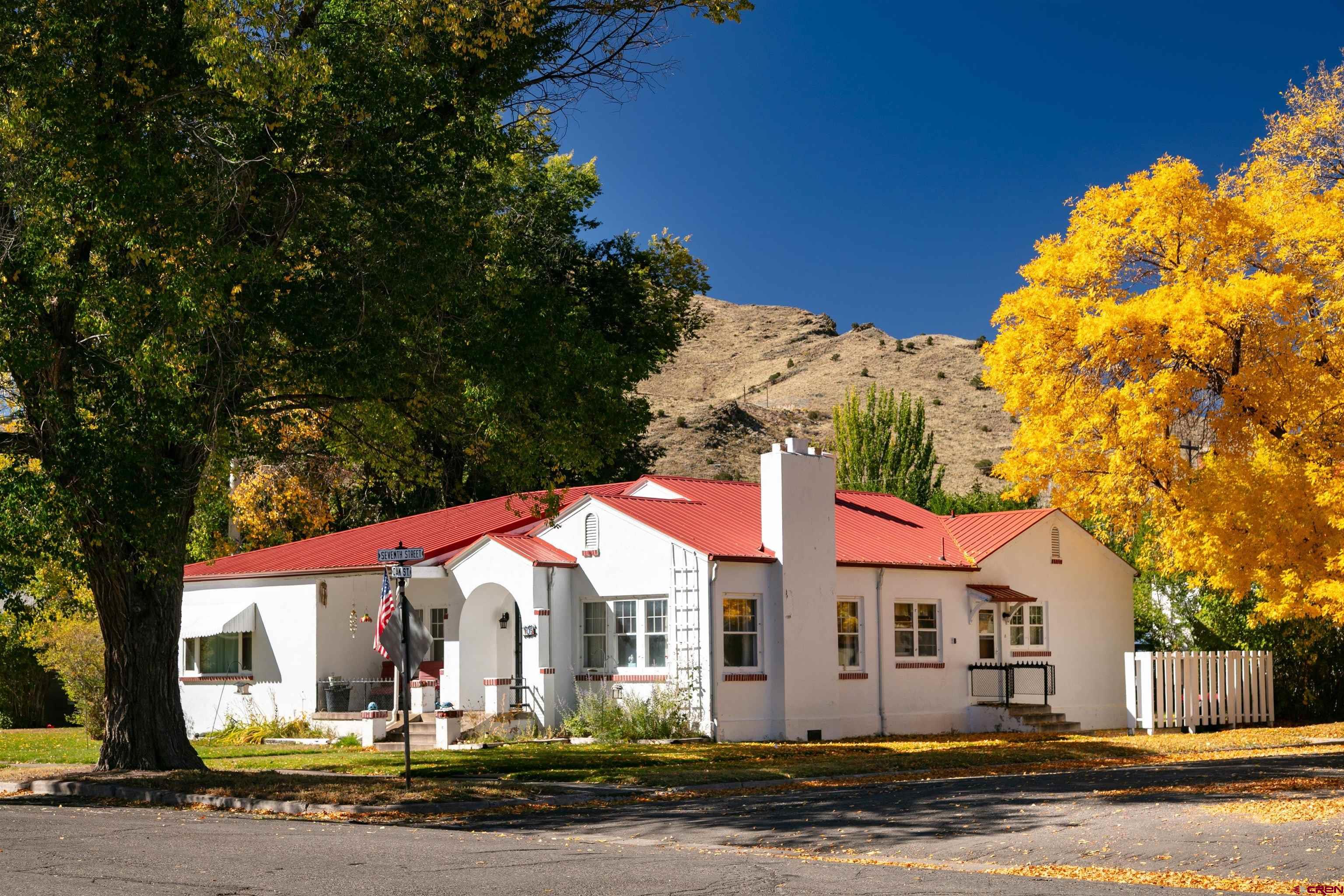 705 Oak Street Del Norte, CO 81132 - Photo 1 of 44 a front view of a house with a yard