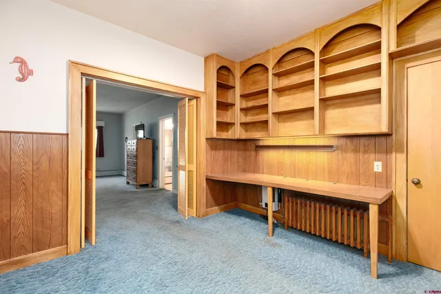 a bedroom with a bed and a table