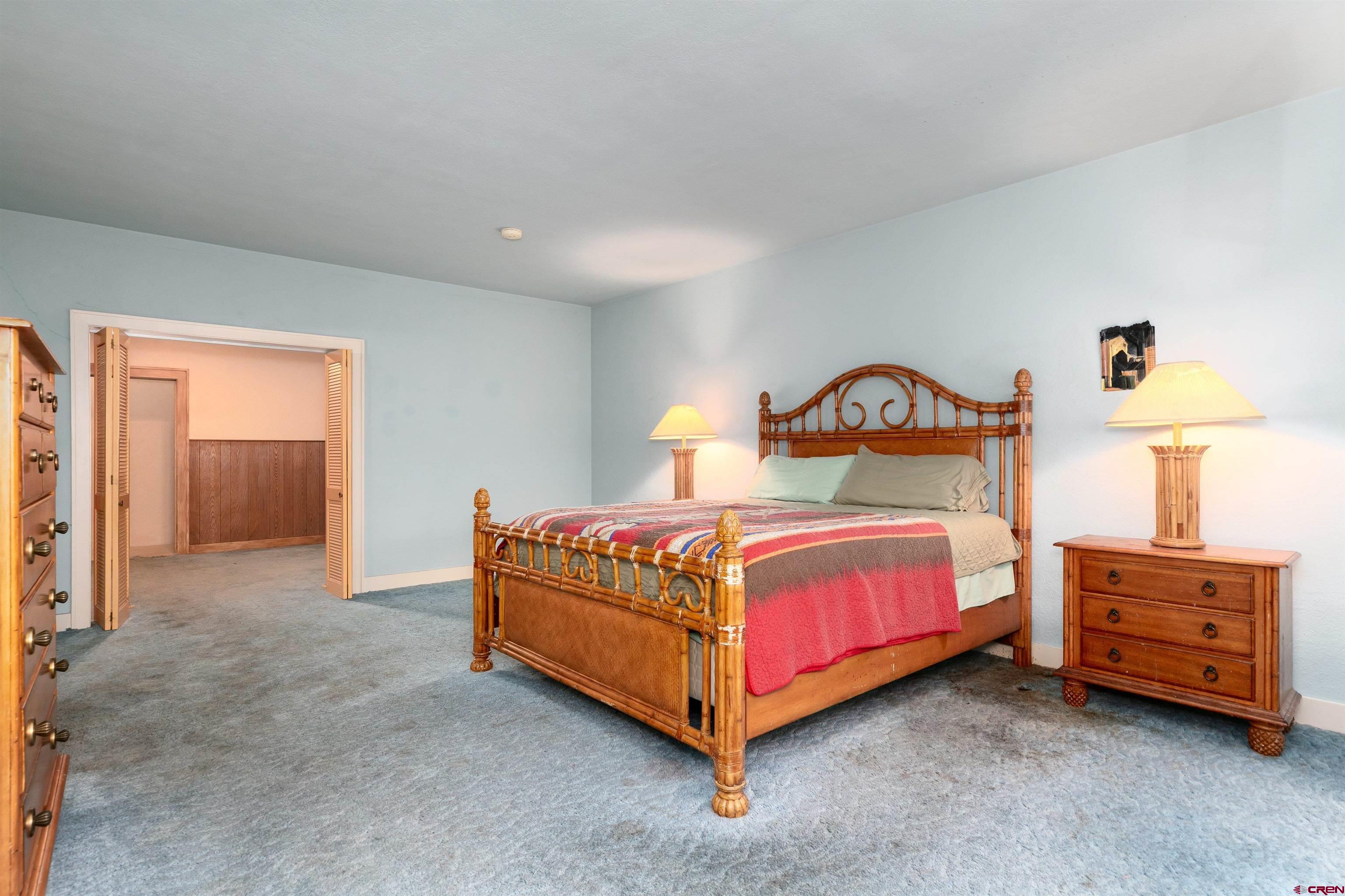 705 Oak Street Del Norte, CO 81132 - Photo 17 of 44 a bedroom with a bed and a table