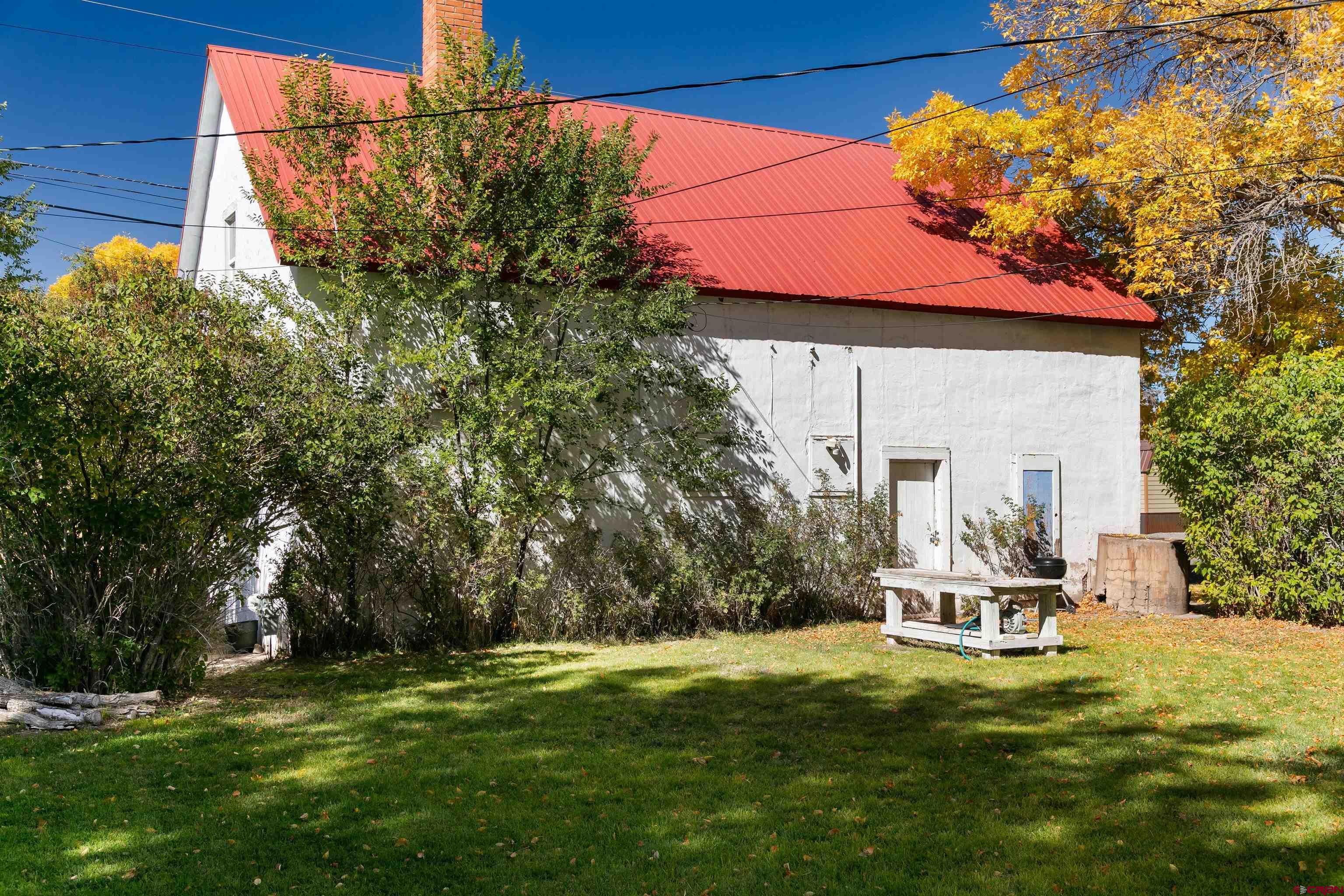 705 Oak Street Del Norte, CO 81132 - Photo 30 of 44 a swimming pool with barbeque oven in front of it