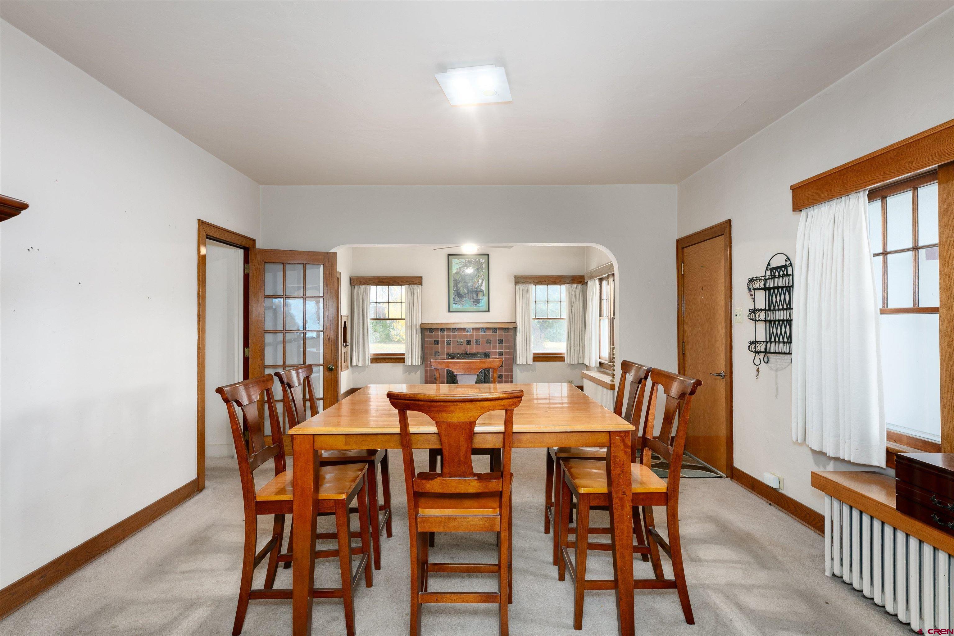 705 Oak Street Del Norte, CO 81132 - Photo 6 of 44 a view of a dining room with furniture and wooden floor