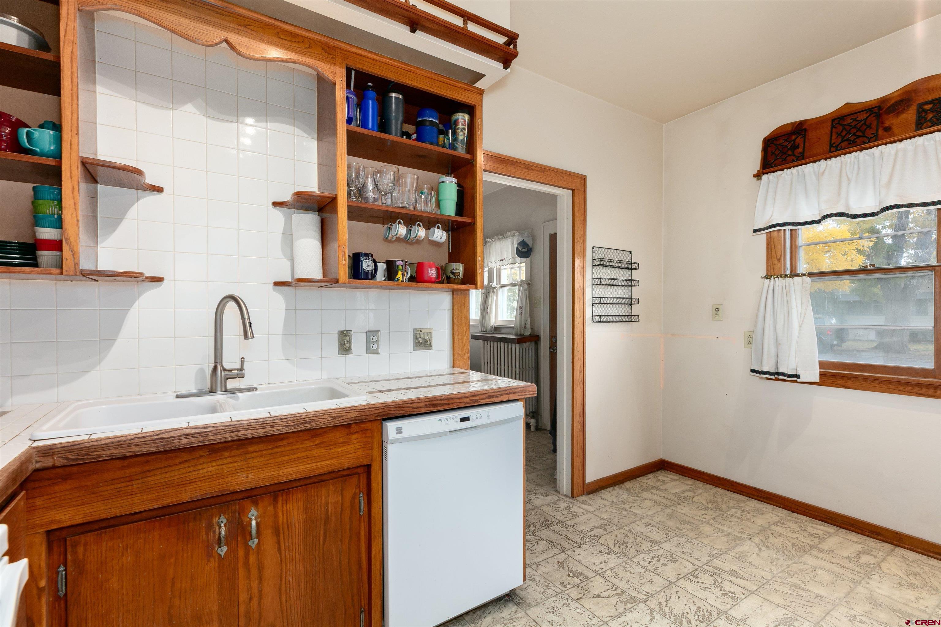 705 Oak Street Del Norte, CO 81132 - Photo 8 of 44 a kitchen with stainless steel appliances granite countertop a refrigerator and a sink