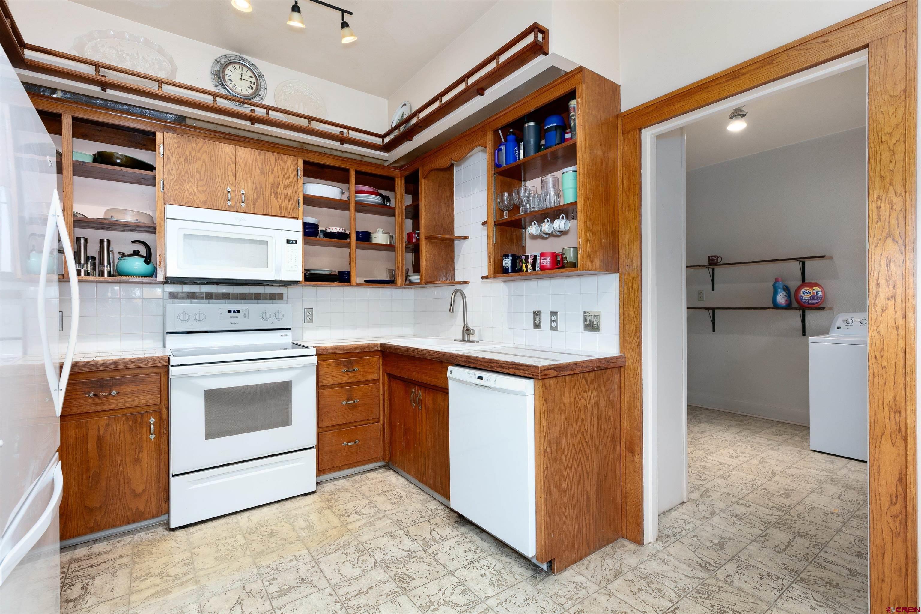705 Oak Street Del Norte, CO 81132 - Photo 10 of 44 a kitchen with stainless steel appliances granite countertop a stove and a sink