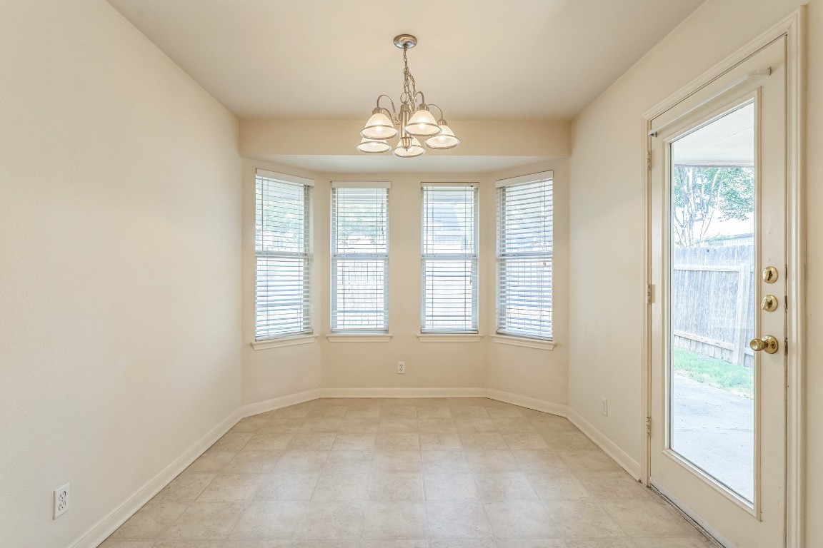 21308 Secretariat Ridge Lane Pflugerville, TX 78660 - Photo 14 of 18 Unfurnished dining area featuring a chandelier and baseboards