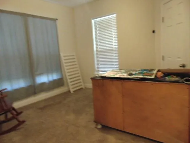 a view of a room with wooden floor and a sink