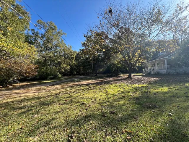a backyard of a house with barbeque oven