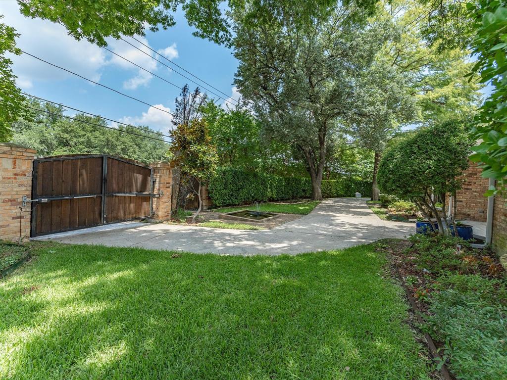 6160 Spring Valley Road Dallas, TX 75240 - Photo 40 of 40 Gated entry featuring a solid wood door set within brick pillars