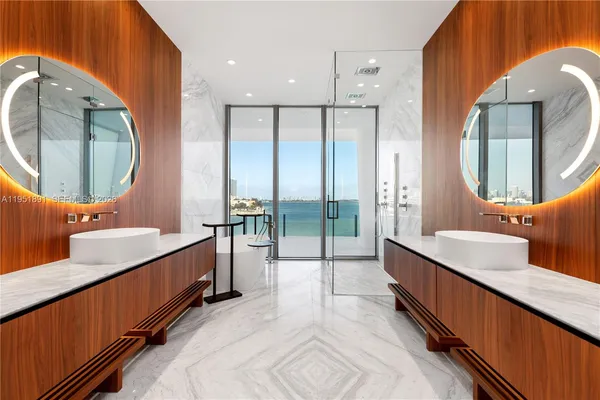 a spacious bathroom with a double vanity sink and a mirror