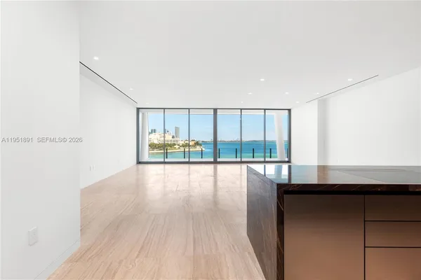 a kitchen with granite countertop a stove and wooden floor