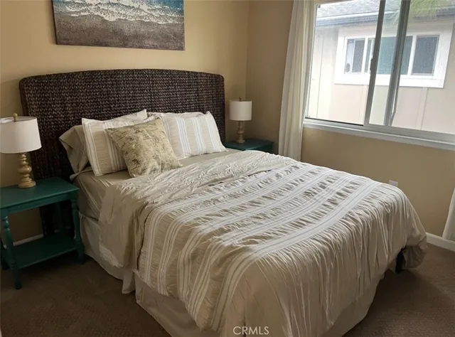 a bedroom with bed and window