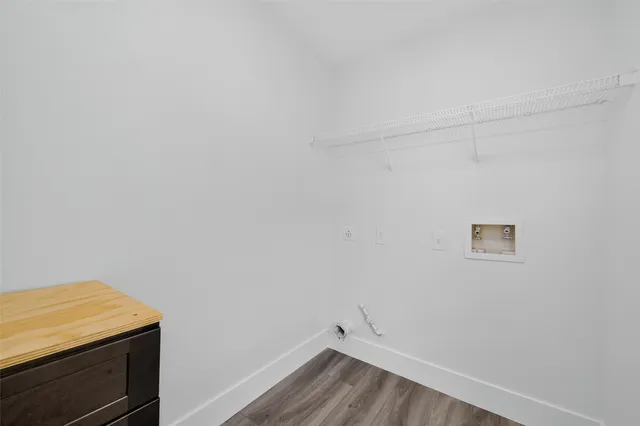 a view of a room with wooden floor