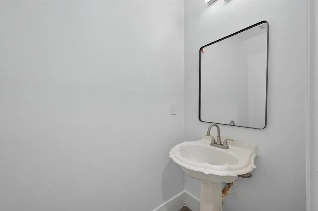 a bathroom with a sink and mirror