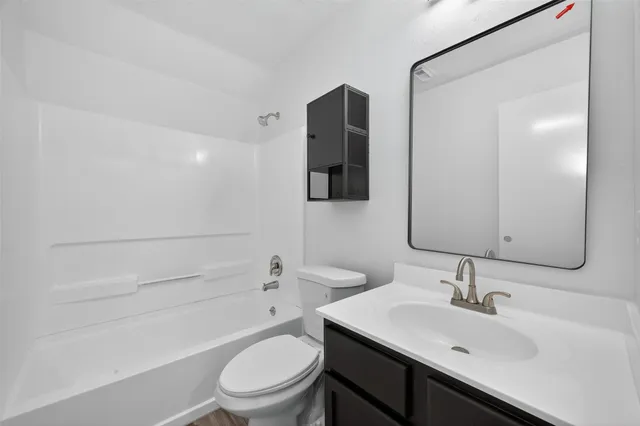a bathroom with a sink toilet and vanity