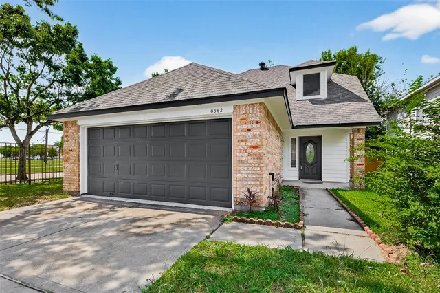 a front view of a house with a yard and garage