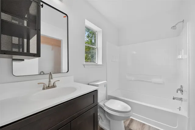 a bathroom with a sink a toilet and a bathtub