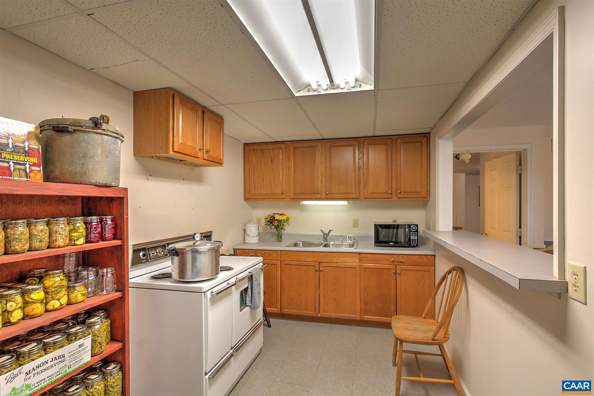 8 Daisy Road Ruckersville, VA 22968 - Photo 24 of 26 a kitchen with stainless steel appliances a sink a stove top oven a counter space and cabinets