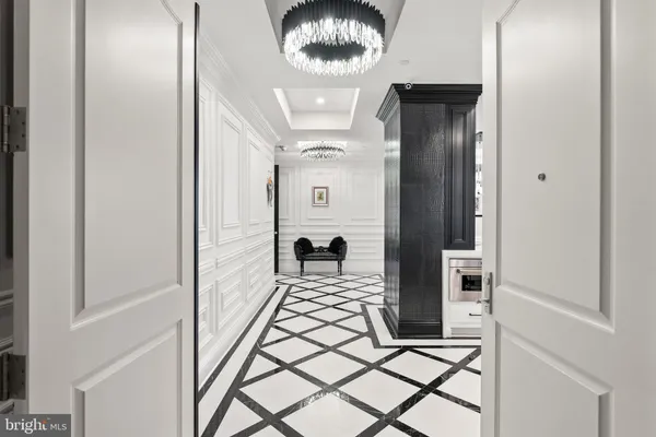 a bedroom with a bed a dresser and potted plants