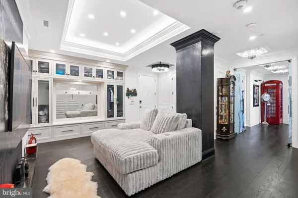 a kitchen with stainless steel appliances kitchen island granite countertop a refrigerator a sink dishwasher and white cabinets with wooden floor