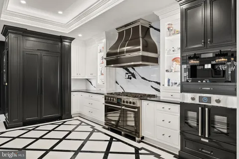 a stove top oven sitting inside of a kitchen